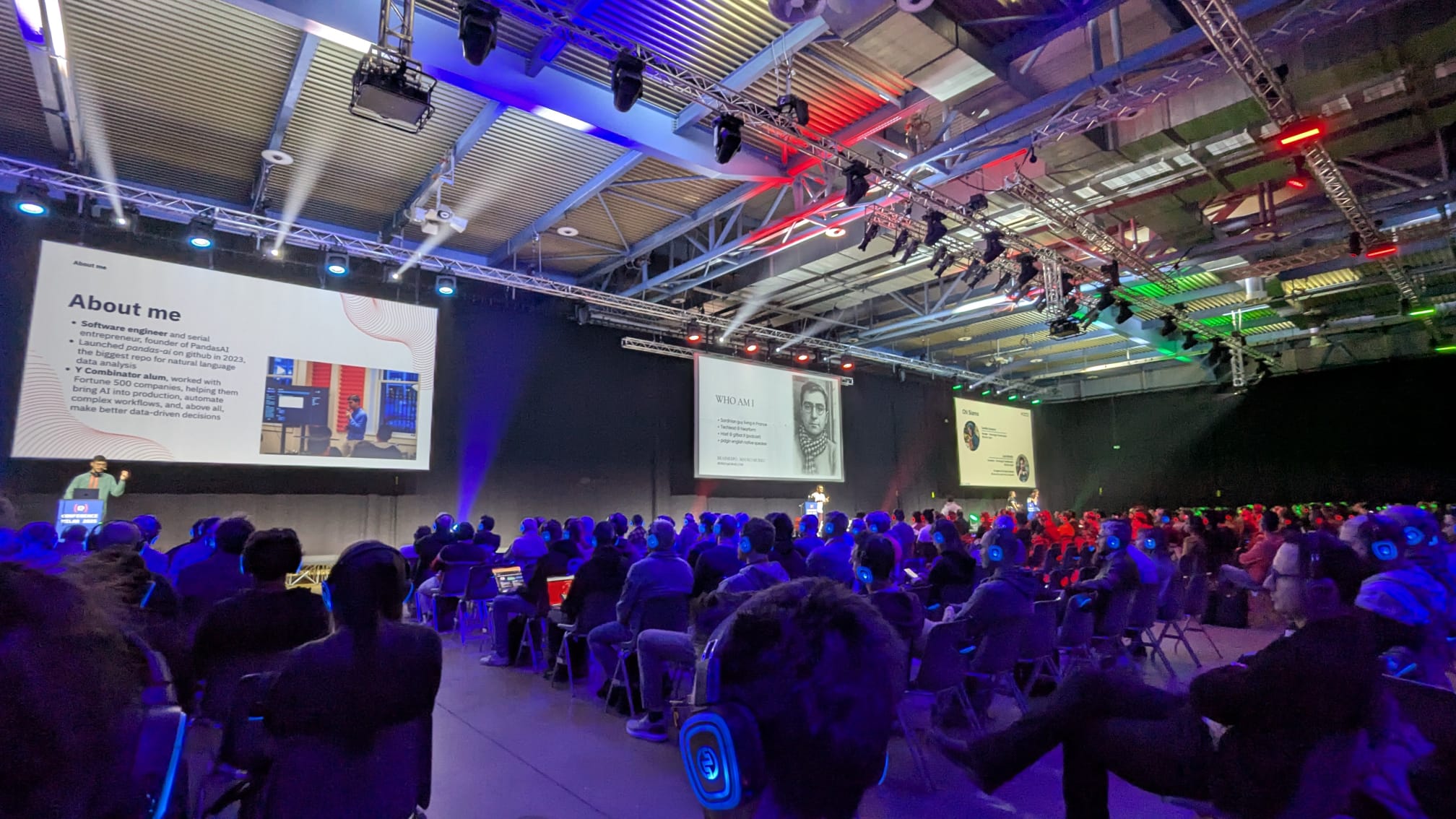 Three of the multiple stages of Codemotion Milan 2025 with the respective speakers presenting to the audience Three of the multiple stages of Codemotion Milan 2025 with the respective speakers presenting to the audience